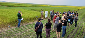 Cory Jacob presenting to people in a field