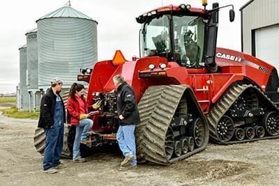 People beside agricultural equipment