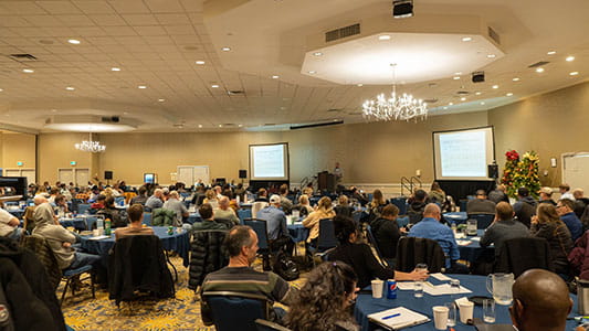 people in banquet hall-type seating in a conference