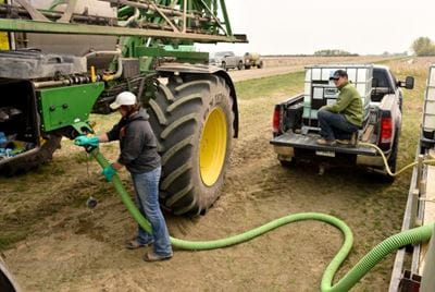 Filling a sprayer Two people filling a self-propelled agricultural sprayer