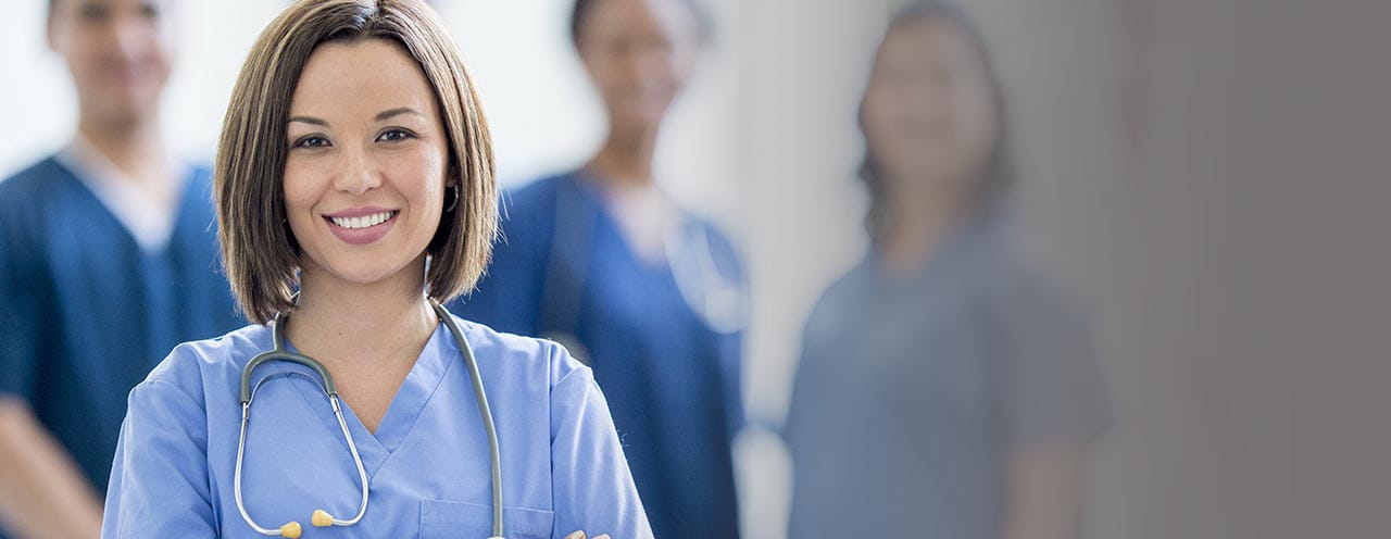 Health care workers in blue scrubs