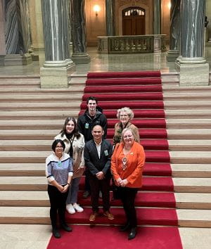 A group of health care professionals on the stairs at the Saskatchewan Legislative Building