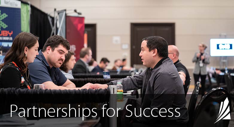 People talking at a tradseshow booth