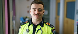 Male Paramedic student in a school hallway 