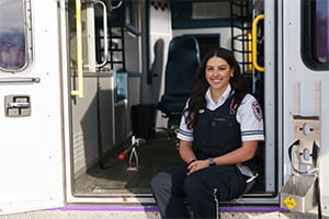 Female Paramedic sitting in the back of an ambulance