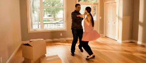 People dancing together in their new home.