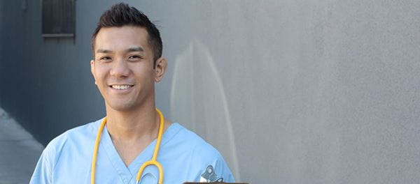 Happy healthcare worker in blue scrubs