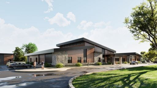 Rendering of a large, modern, partial parallel bungalow home (grey, brown and black). The image shows a blue sky with landscaped greenery and puddles in the parking lot. Seven people are dispersed on the sidewalk outside the home.