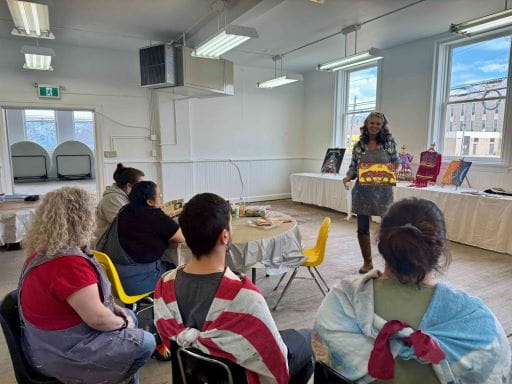 Instructor standing at the front of a room holding a piece of art as she leads an art class. Several members  are sitting in chairs listening. Arts councils are part of a network of community organizers that connect with the Organization of Saskatchewan Arts Councils to access professional artists, receive support in running quality exhibitions and performances, and access other professional development opportunities.  Across Canada, National Volunteer Week is being celebrated from April 19 to 25. Help us thank these ordinary superstars who live next door to us ? people of all cultures, ages, and abilities.